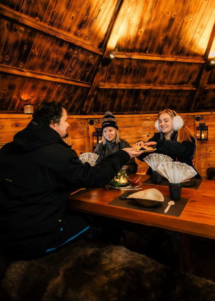 Warm pastries shared at the candlelit table of a Lappish hut