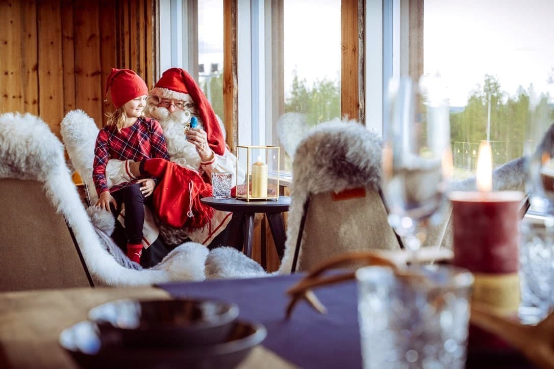 Santa Claus and a child sharing a quiet moment at a Lapland villa