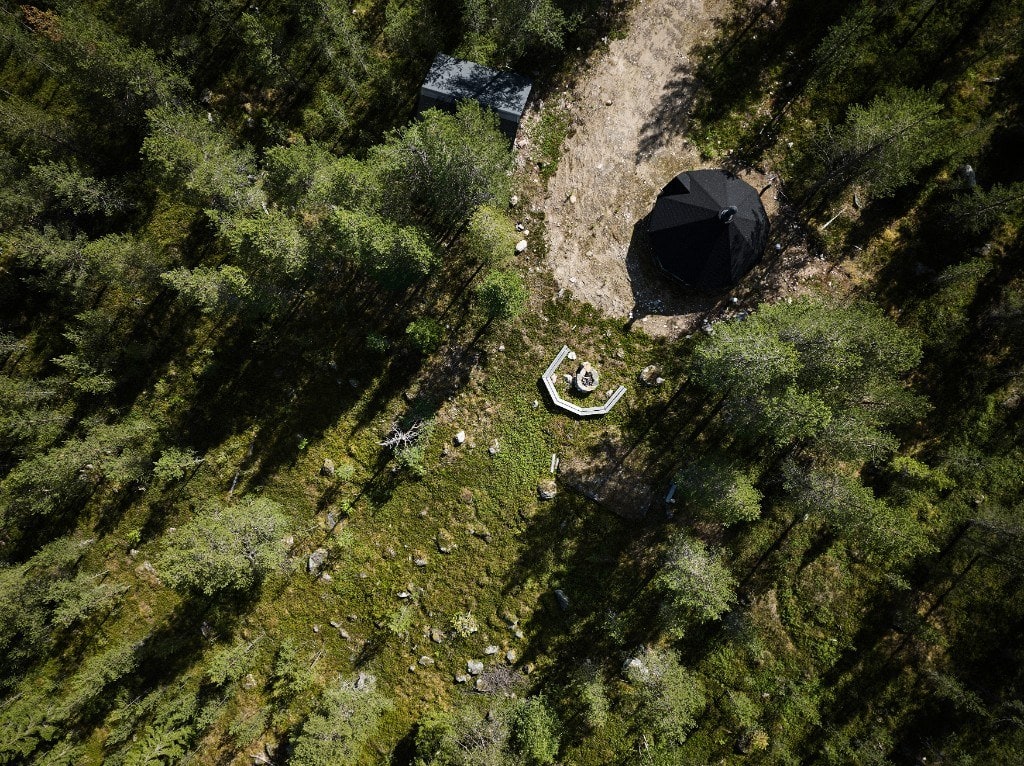 A Lappish kota hut and fire pit seen from above in summer