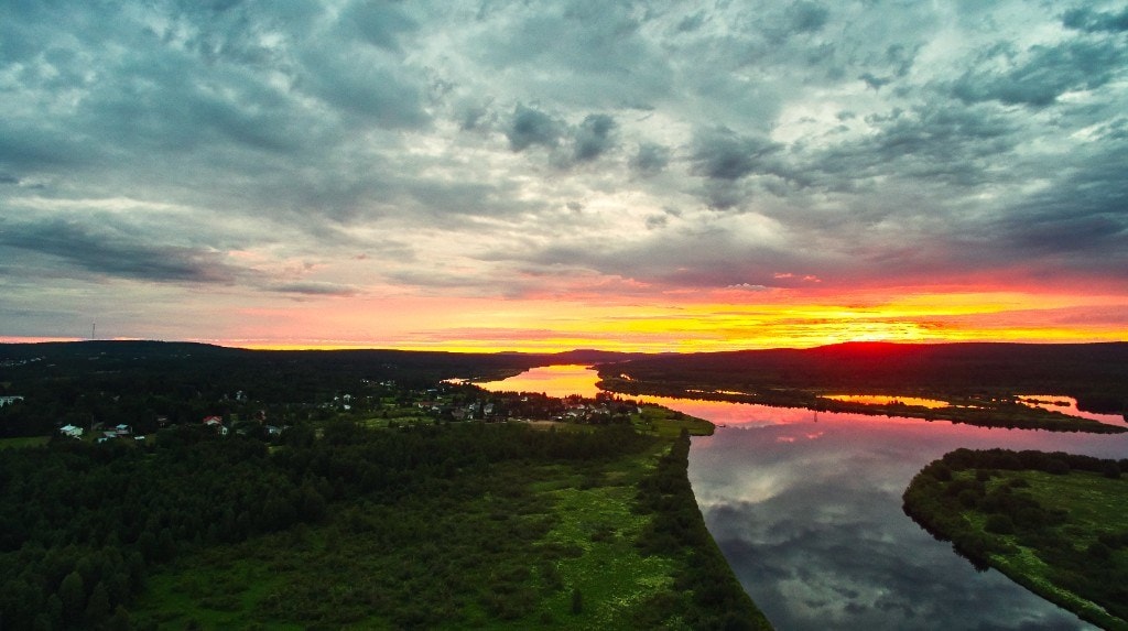 The midnight sun burning over a river valley in Finnish Lapland